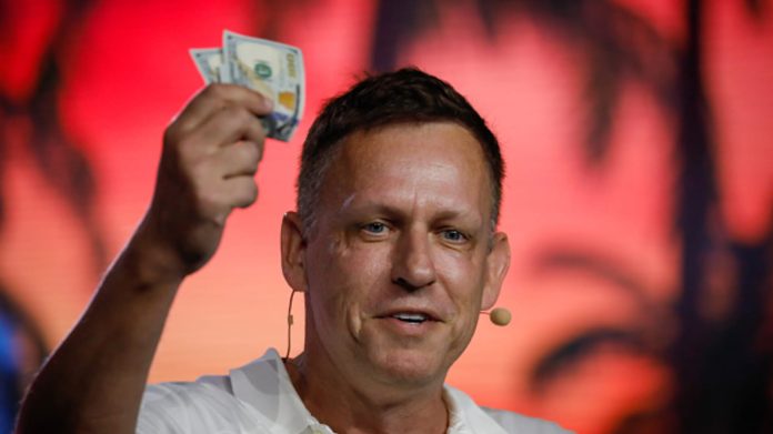 Person holding two US dollar bills.