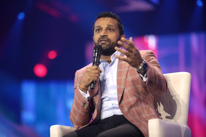 Kash Patel speaking into a microphone on a stage.
